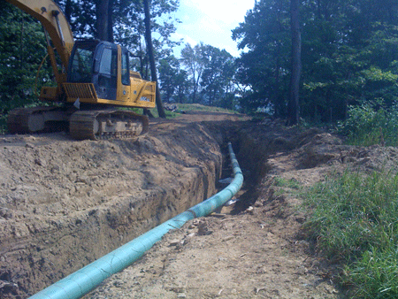 Active EQT pipeline project running next to a completed well head (there is a large frac evaporation and crystallization pond next to it). Waynesburg, PA in September, 2010.Photo credit - Josephine Sabillon