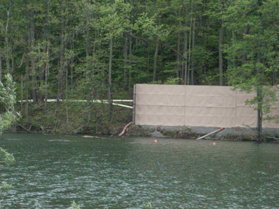 Fresh water being withdrawn from small lake in Washington Co., PA to fracture well. White pipes emerging from behind blind lead to a staging area 2 mi. away. Photo credit - Josephine Sabillon