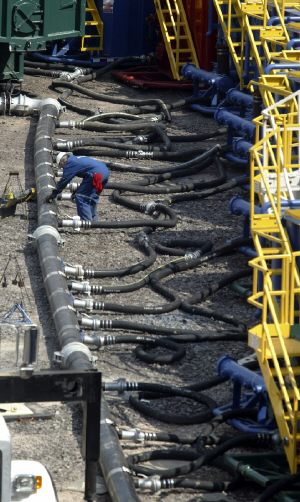 Worker adjusting water line used in hydro-fracturing a Marcellus well in Dimock Township, Susquehanna County, PA. Courtesy of Michael J. Mullen, Staff Photographer, Scranton Times-Tribune